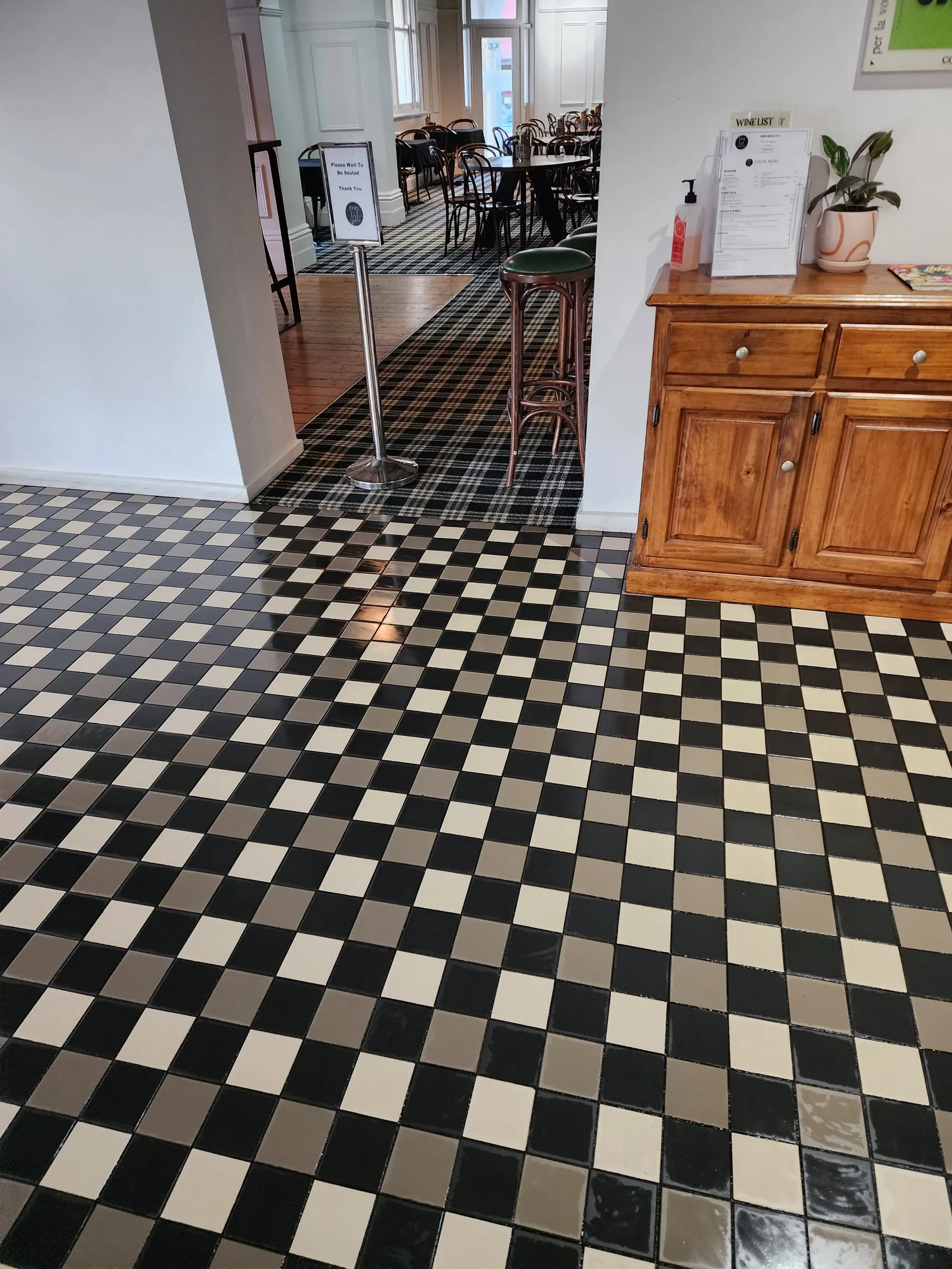 Black-and-white checkerboard floor beside a bar counter