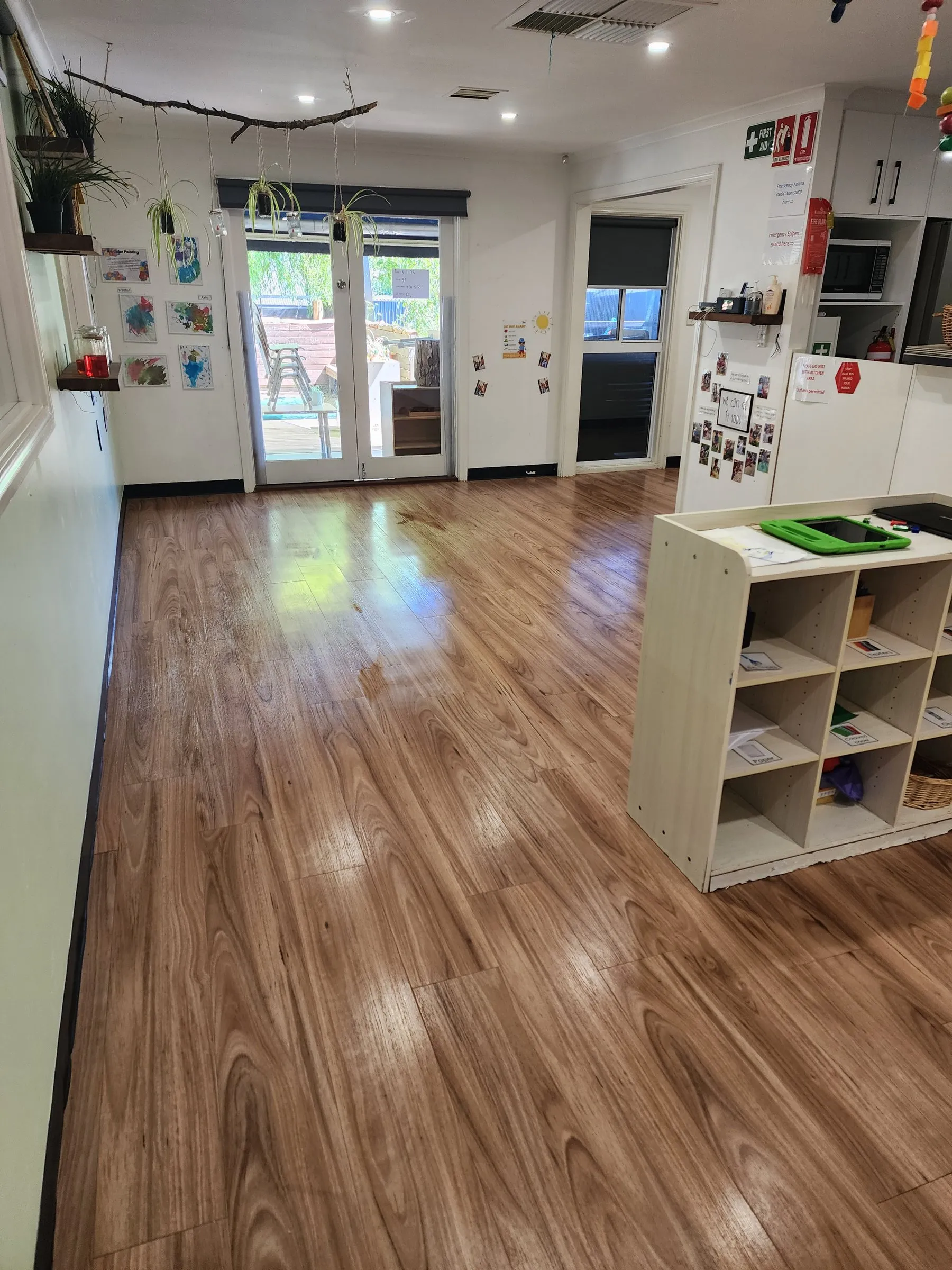 Room with a polished timber-look floor and a low cube shelf