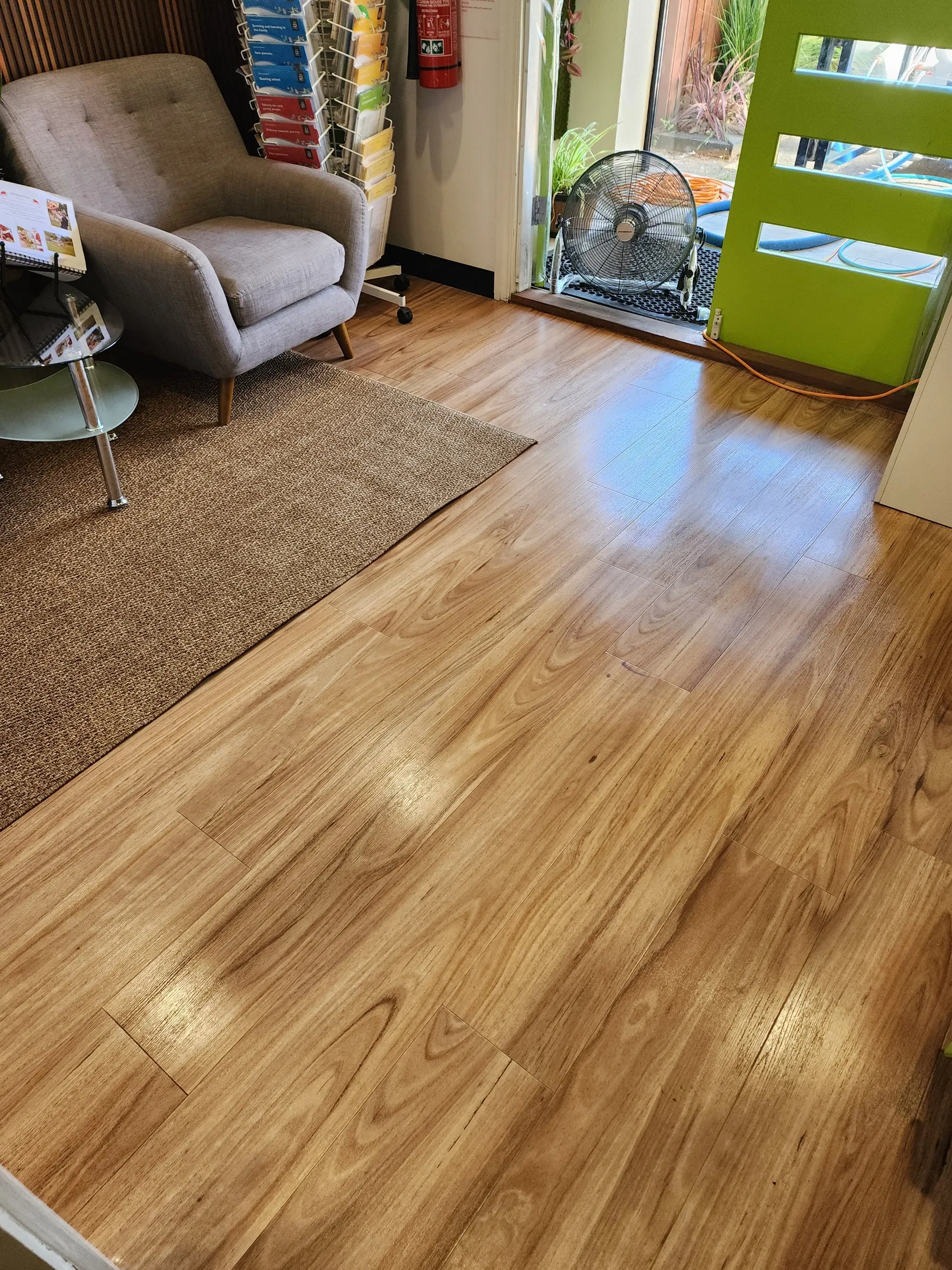 Reception lounge with an armchair on a clean timber floor