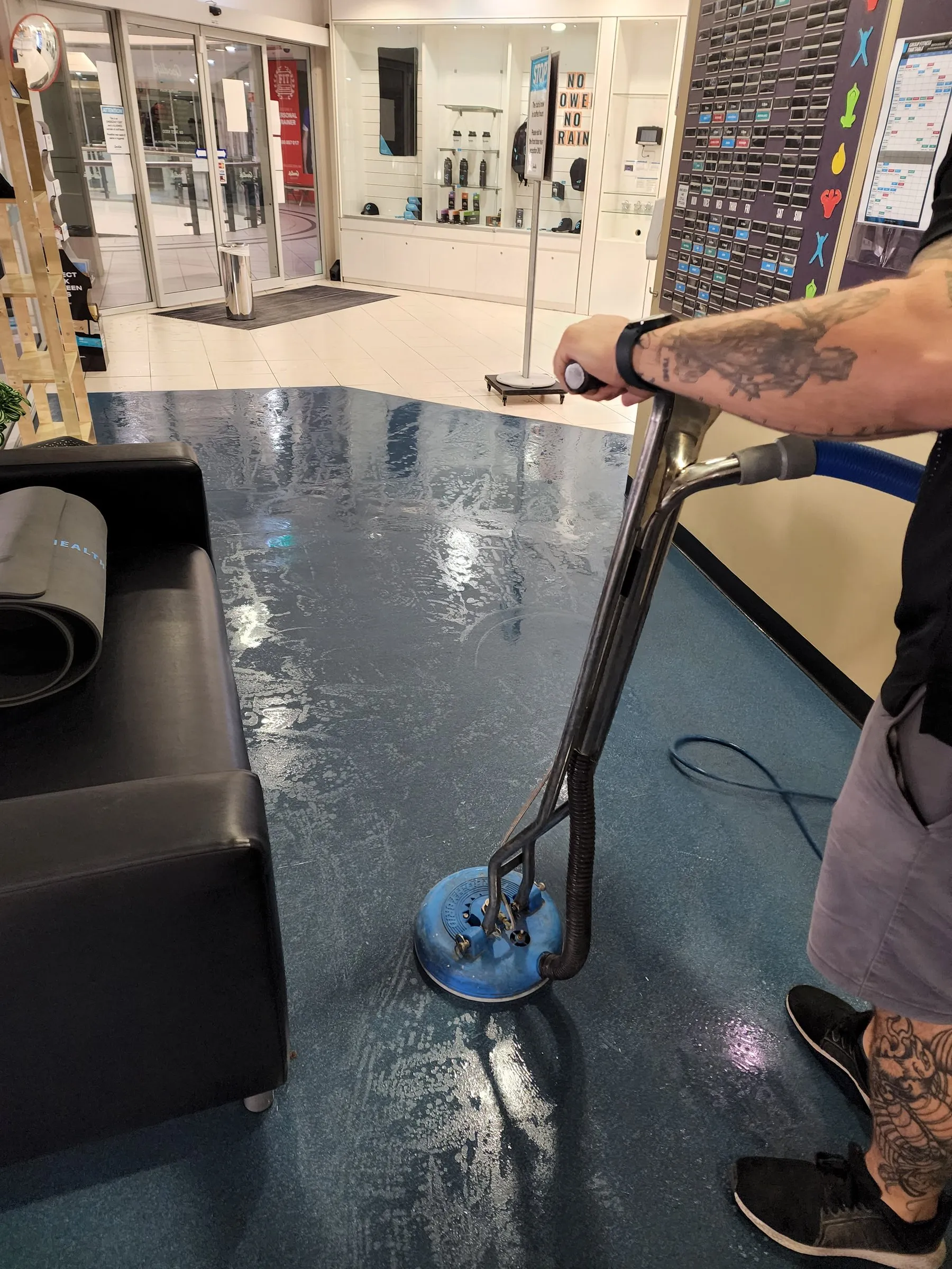Spinner wand scrubbing a blue vinyl floor